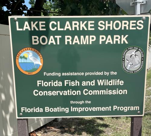 Green sign that says "Lake Clarke Shores Boat Ramp Park"
