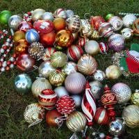 Assorted tree ornaments on the grass. 