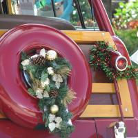 Wreath with bells on the back of a red and gold vintage car