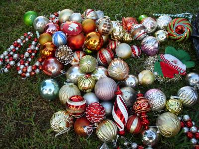 Assorted tree ornaments on the grass. 