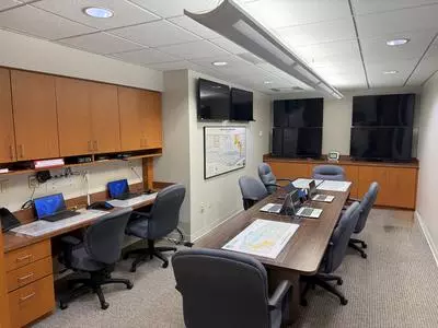 EOC Office with televisions, computers, desks, chairs and cabinets