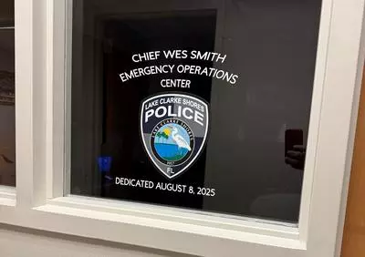 Police logo and writing on the EOC window stating: Chief Wes Smith Emergency Operations Center dedicated August 8, 2025
