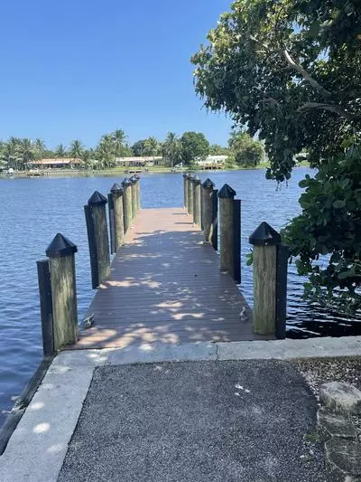 Boat ramp park dock at daytime. Background of lake and multiple lighting posts